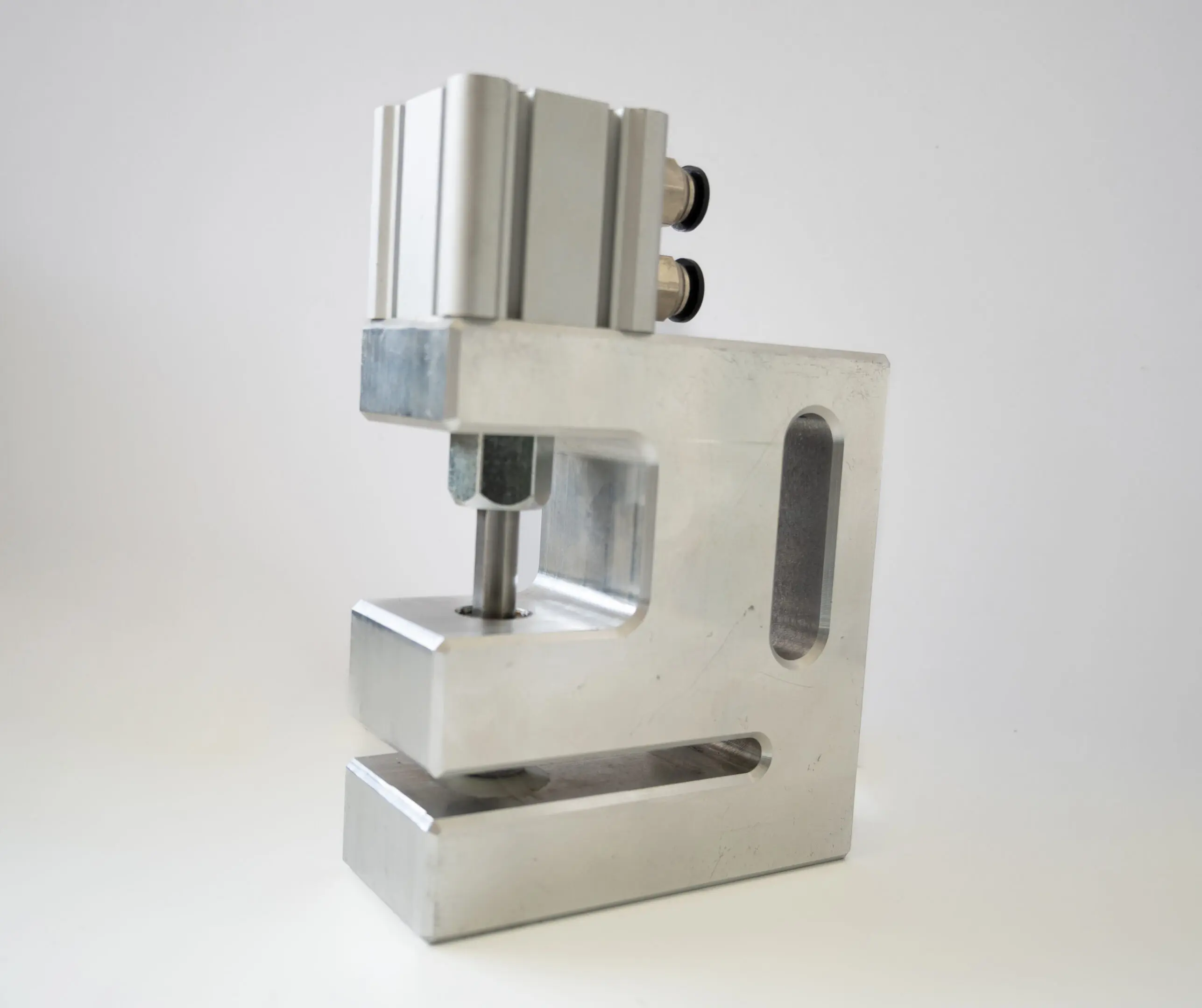 Compact metal device with cylindrical components, possibly a specialized tool.