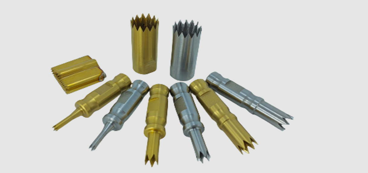 Metallic hole cutters arranged on a surface.